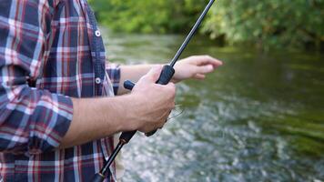 Fly fishing reel with river water. Fly fisherman catches fish video