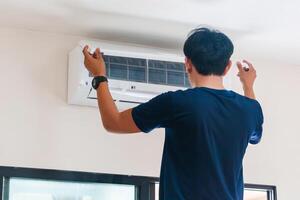 Technician man install new air conditioner, Repairman service for repair and maintenance of air conditioners photo