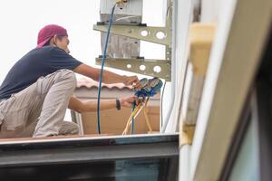 Technician man install new air conditioner, Repairman service for repair and maintenance of air conditioners photo