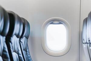 Window in cabin, Airplane seat with window, economy class leather seats with window in airplane photo