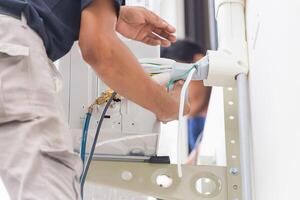 Technician team install new air conditioner, Repairman service for repair and maintenance of air conditioners photo