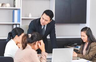 Serious meeting, managers with diverse coworkers team at meeting room. Group of coworkers in a conference room during the meeting photo