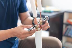 Technician man using a wrench to fix and joints copper pipe in air conditioner system, repair service and install new air conditioning concepts photo