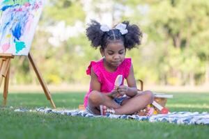 Child girl playing outdoors, Cute little girl play in the garden, Pretty baby girl kid eating ice cream photo