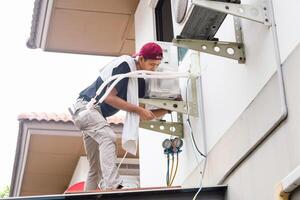 Technician man team install new air conditioner, Repairman service for repair and maintenance of air conditioners photo