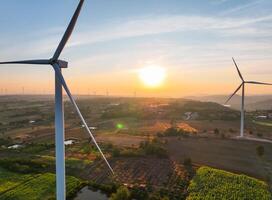 Wind farm field and sunset sky. Wind power. Sustainable, renewable energy. Wind turbines generate electricity. Sustainable development. Green technology for energy sustainability. Eco-friendly energy. photo