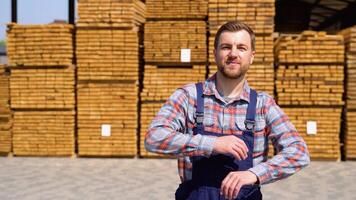 Young male worker in timber lumber warehouse video