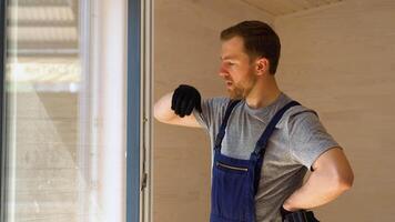 Portrait of window installer with screwdriver in wooden prefabricated house video