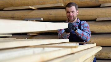 Young male worker in timber warehouse video