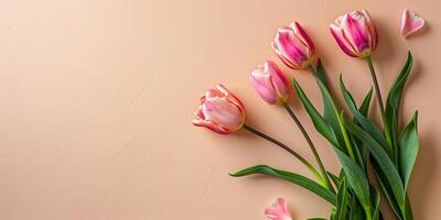 Flat Lay of Vivid Spring Flower Arrangement on Pastel Beige Background photo