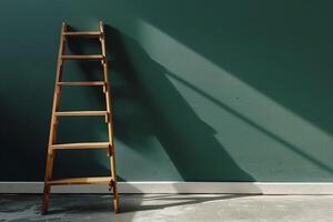A ladder leaning against a wall with a pastel dark green color with copy space photo