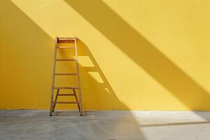 A ladder leaning against a wall with a yellow color with copy space photo