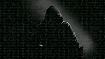 Anonymous man in a hood interview footage. Mysterious man sitting on a chair and talking. Anonymous hacker interview with no visible face, computer hacker conceptual background video