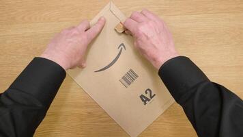 Sacramento, United States, January 19, 2024. Amazon cardboard envelopes peel. Unpacking an envelope from a courier video