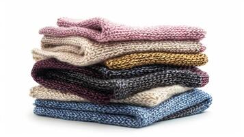 A stack of cozy handknit scarves made from a luxurious blend of bamboo and cashmere fibers perfect for chilly winter days photo