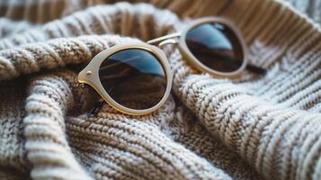 A pair of vintage sunglasses evoking a sense of nostalgia and style are found ast a pile of accessories and are the perfect finishing touch for any outfit photo