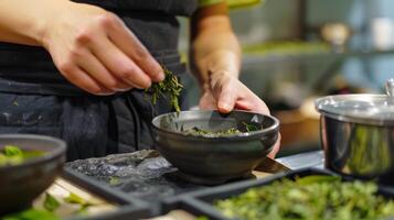 A person measuring out the perfect amount of tea leaves using a traditional sized scale photo