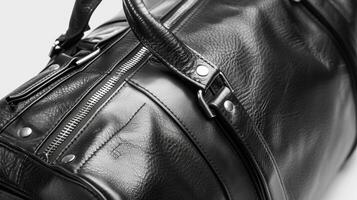 A black leather duffel bag with metallic accents and luxurious lining representing the mix of practicality and luxury in designer mens accessories photo