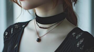 Playing with textures by layering a velvet choker with a delicate chain featuring a druzy stone pendant photo