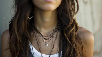 Effortlessly cool with a combination of leather and metal necklaces layered over a basic tshirt or tank top photo