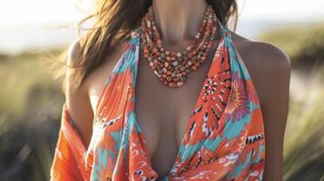 Amp up your seaside style in a colorful sarong wrap dress with a plunging neckline and a bold statement necklace photo