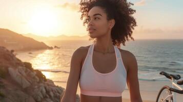 A pastel pink sports bra and matching bike shorts topped with a white mesh coverup perfect for a morning jog or bike ride on the beach. The early sunrise and gentle breez photo