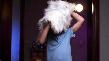 boy in a wolf mask for Halloween. boy takes off his mask and smiles video