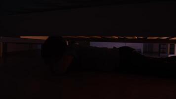 frightened sad lonely little boy crying under the bed during a thunderstorm video