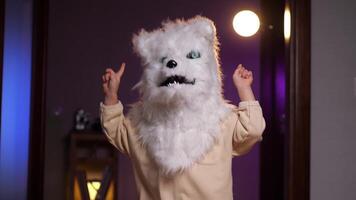 little child dancing and rejoicing in a wolf mask for halloween video