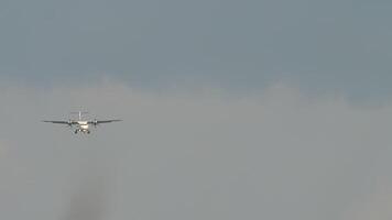 Airplane approaching. Twin-engine turboprop short-haul regional passenger aircraft. Landing airplane. Blue sky background video