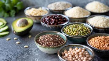 A variety of nutritious ingredients like quinoa beans and avocados are neatly arranged on the countertop waiting to be transformed into a nourishing meal photo