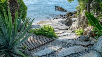A private beach cove with a small wooden platform surrounded by rocks and plants ideal for beachside meditation photo