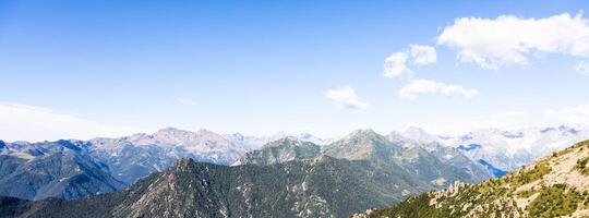 Panorama of Italian Alps with blue sky and cloud. Calm landscape, tranquil scenic view. photo