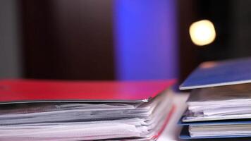 close-up of colored folders with documents are stacked on the table video