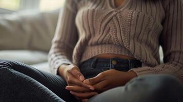 A close up image of a persons hands resting on their stomach as they concentrate on deep breathing with a quote about the importance of mindful breathing photo