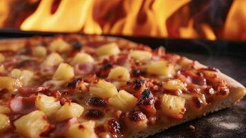 Juicy chunks of pineapple and savory ham adorn a hot pizza slice radiating warmth and comfort against the fiery flames behind it photo