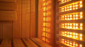 A closeup of the infrared light panel inside the sauna emitting a soft glow that is said to trate deep into the bodys tissues and promote healing. photo