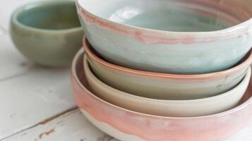 A set of nesting bowls each one a different size and each one showcasing a different custom blend of clay that gives the bowls their beautiful pastel hues. photo