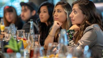 The participants carefully follow along attentively listening to the instructors tips and tricks for creating the perfect balance of flavors in their mocktails photo