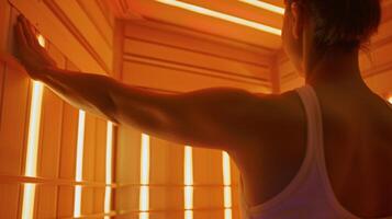 A person slowly stretching their arms and legs while inside the infrared sauna working out any muscle tightness and tension. photo