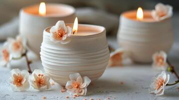 A completed votive holder adorned with small clay flowers adding a delicate touch to the simple design. photo