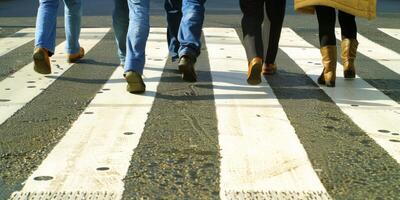 pedestrians on a zebra crossing crossing the street photo