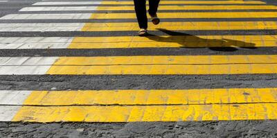 pedestrians on a zebra crossing crossing the street photo