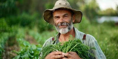 Farmer holding greens from the garden in his hands photo