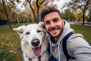 Selfie of a man with a dog in the park photo