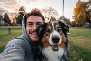 Selfie of a man with a dog in the park photo