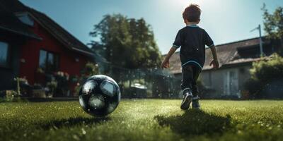 child boy playing football in the backyard photo