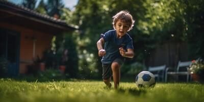 child boy playing football in the backyard photo