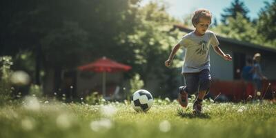 child boy playing football in the backyard photo