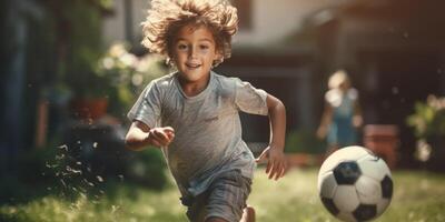 child boy playing football in the backyard photo